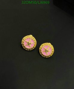 Gold earrings with pink enamel and star design.