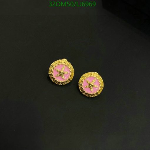 Gold earrings with pink enamel and star design.