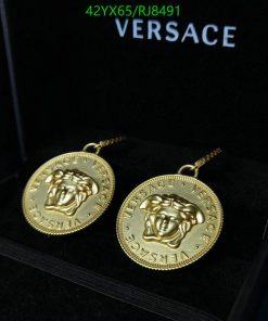 Gold Versace medusa head earrings in box