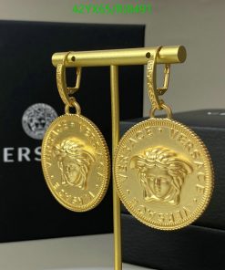 Gold Versace medallion earrings on display.