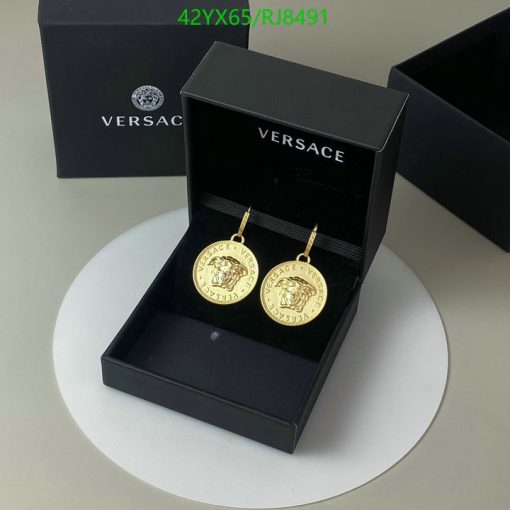 Versace gold medallion earrings in black box.