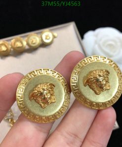 Gold lion head earrings with Greek key design.