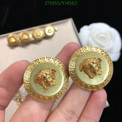 Gold lion head earrings with Greek key design.