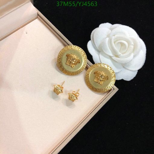 Gold lion earrings with white flower decoration.