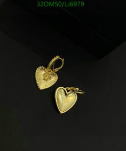 Gold heart-shaped pendants on black background.