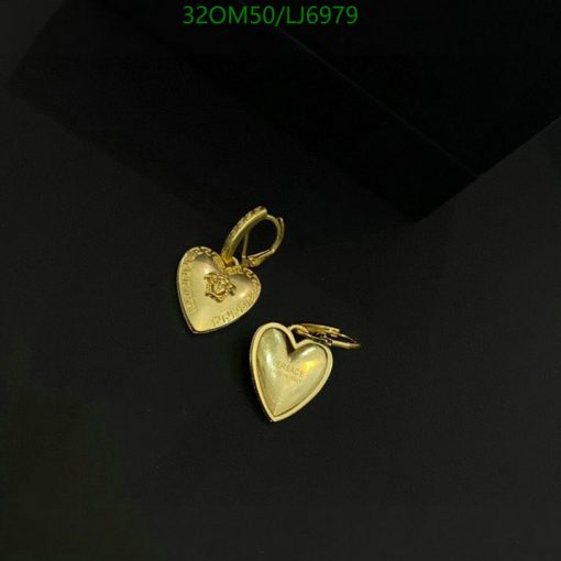 Gold heart-shaped pendants on black background.