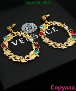 Versace gold-tone bracelets with colored gemstones.