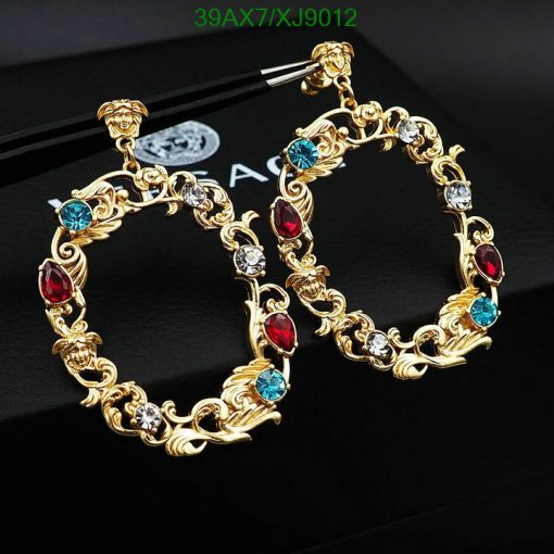 Gold hoop earrings with red and blue gemstones.