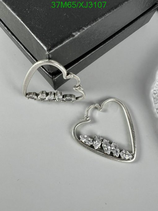 Silver heart-shaped earrings with diamonds on display.