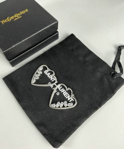 Designer heart-shaped earrings with branded box and pouch.