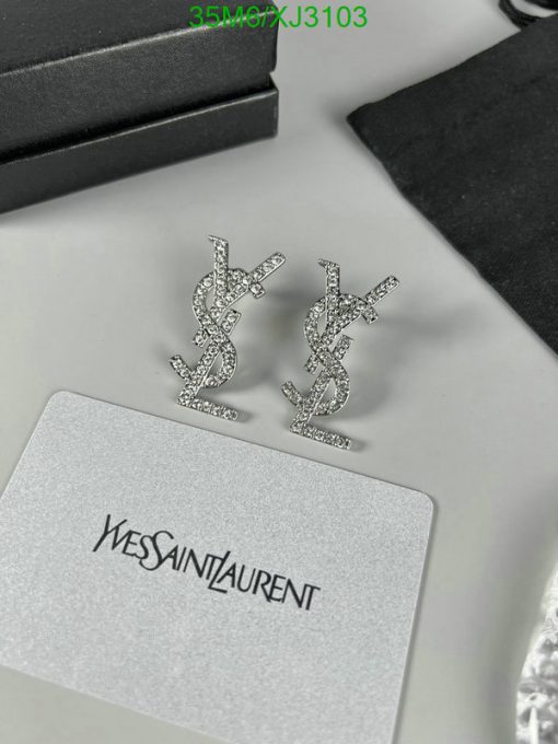 Designer logo earrings with sparkling stones on display.