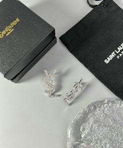 Designer logo earrings with packaging on white background.