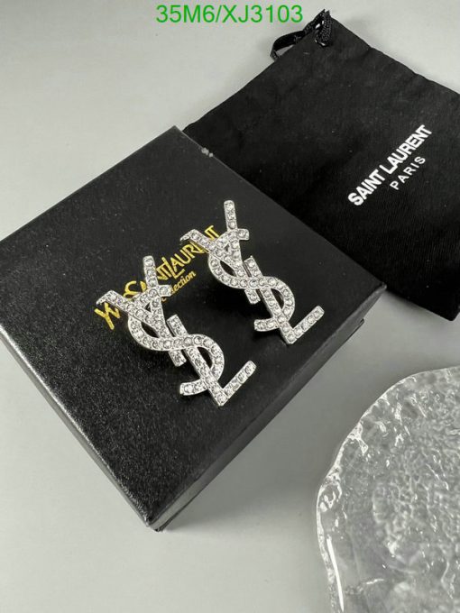 Designer logo earrings with packaging on table.