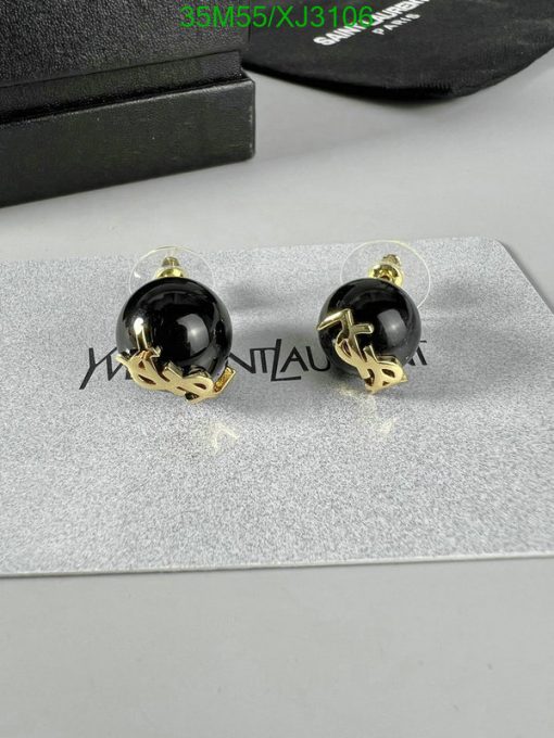 Black and gold designer earrings on display.