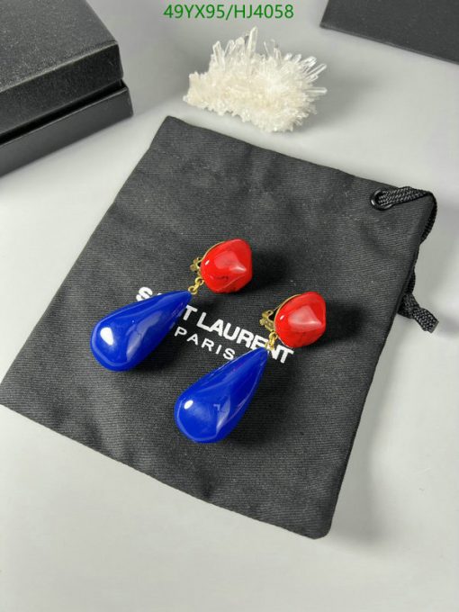 Blue and red drop earrings on designer pouch.