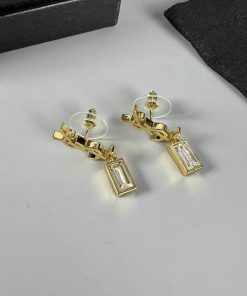 Gold rectangular drop earrings on white background.