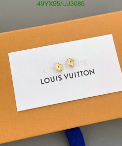 Gold flower earrings on Louis Vuitton packaging.