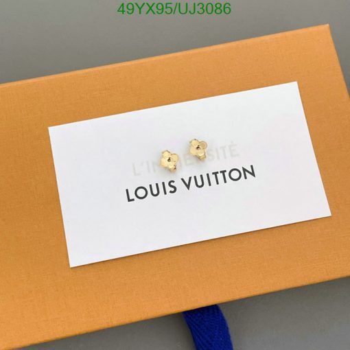 Gold flower earrings on Louis Vuitton packaging.