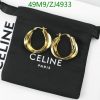 Gold hoop earrings on black Celine pouch.