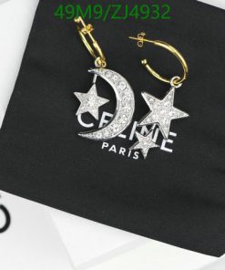 Designer star and moon earrings on branding pouch.