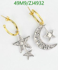 Star and moon diamond earrings on white.