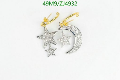 Star and moon diamond earrings on white background.