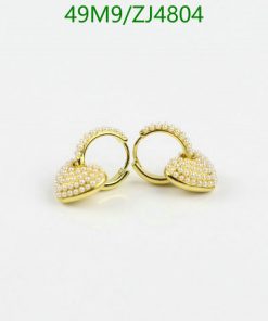 Gold pearl-studded hoop earrings on white background.