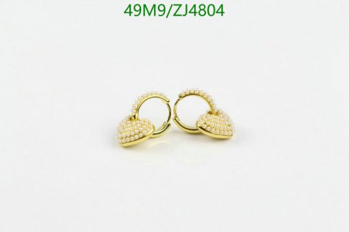 Gold pearl-studded hoop earrings on white background.