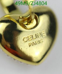 Gold heart-shaped pendant with engraving on white background.