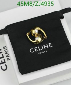 Gold earring on Celine Paris branded pouch.