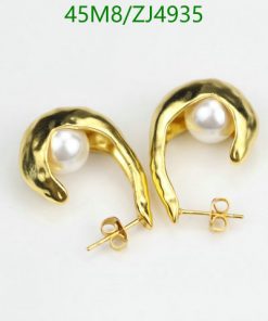 Gold pearl earrings on white background.