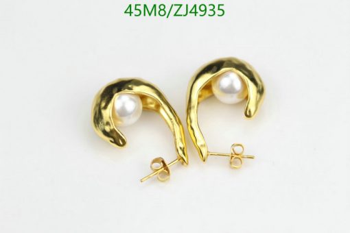 Gold pearl earrings on white background.