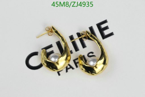 Gold hoop earrings with pearls on white background.