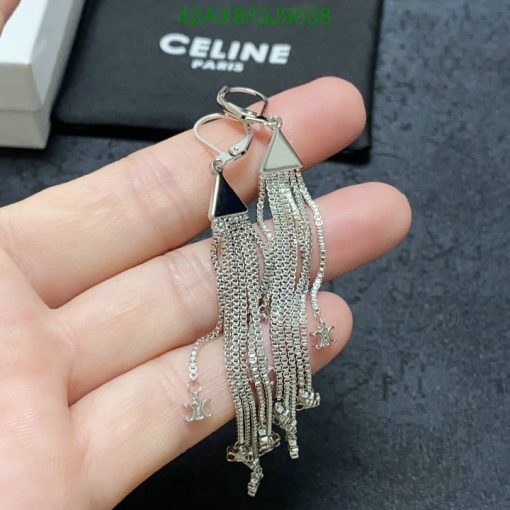 Silver tassel earrings held in hand.