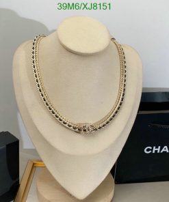 Gold necklace on mannequin with branded box.