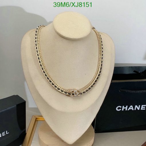 Gold necklace on mannequin with branded box.