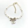 Pearl necklace with rhinestone bow pendant.