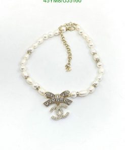 Pearl necklace with rhinestone bow pendant.