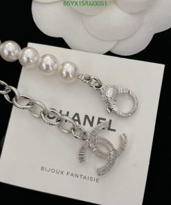 Designer silver bracelet with pearl detail on white background.