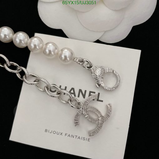 Designer silver bracelet with pearl detail on white background.