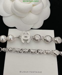 Silver jewelry with pearls on white background.