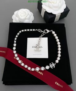 Elegant pearl and crystal necklace on branded display.