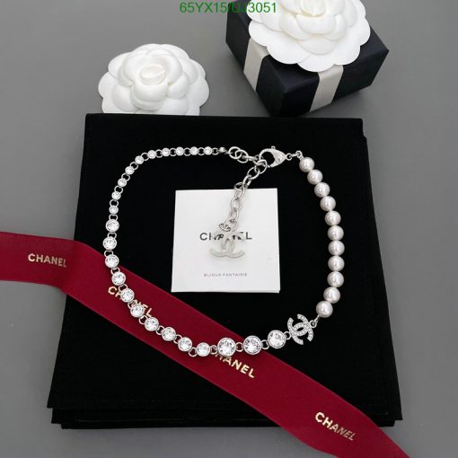 Elegant pearl and crystal necklace on branded display.