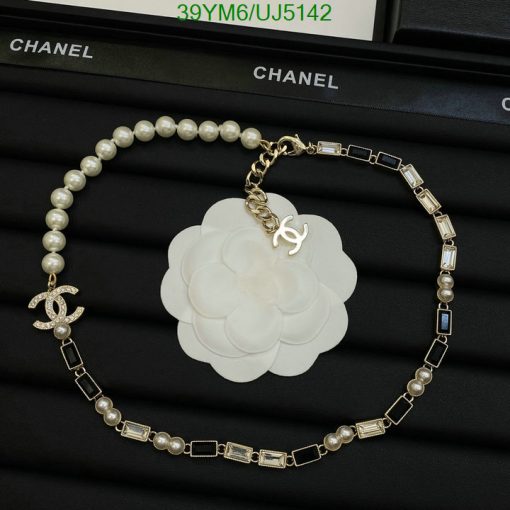 Chanel pearl bracelet with flower charm on display.