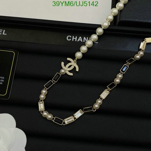 Pearl necklace with designer logo on display