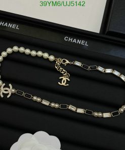 Chanel pearl and crystal necklace on black display.