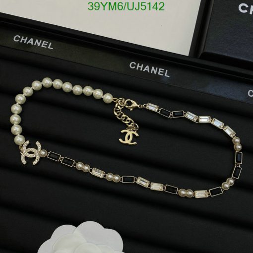 Chanel pearl and crystal necklace on black display.