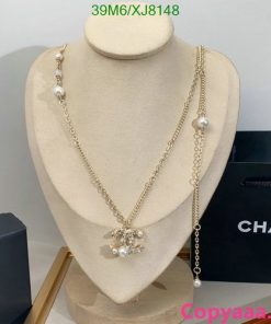 Elegant pearl and gold Chanel necklace on display.