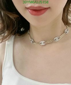 Woman wearing a diamond necklace.