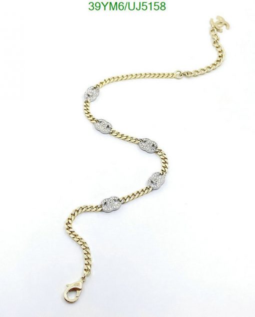 Gold chain bracelet with diamond accents.